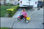 Tulia learning to ride a tricycle